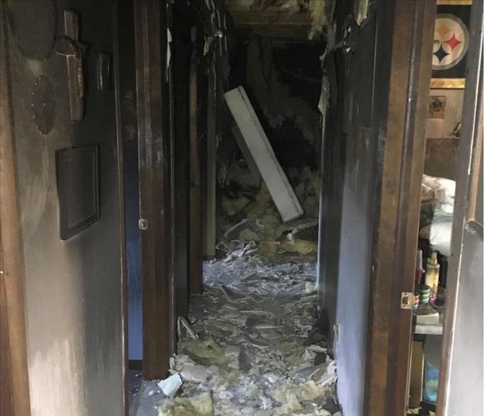 image of residential hallway very damaged by a home fire 