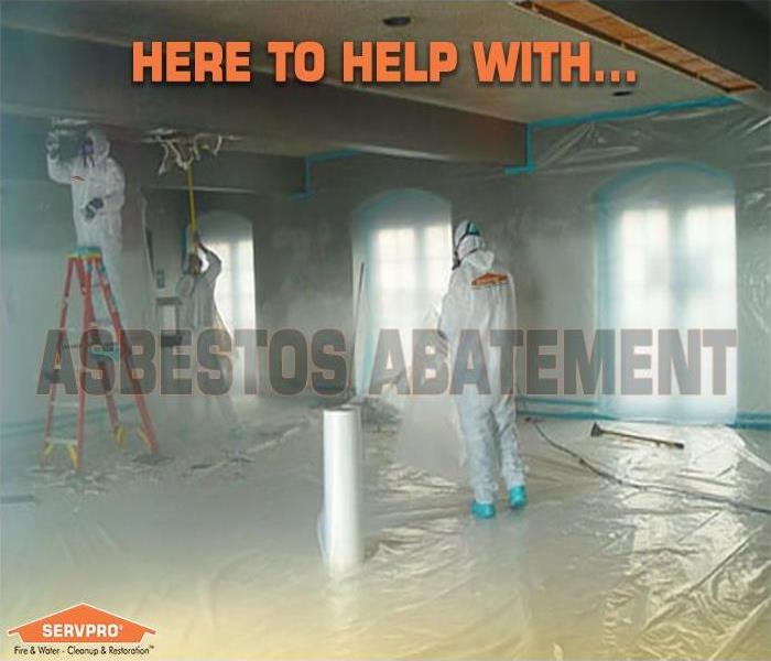 photo of workers in PPE suits performing asbestos abatement
